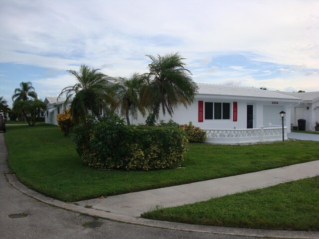 single story home with a garage and a front yard