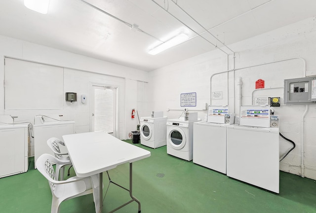 laundry room with electric panel and separate washer and dryer