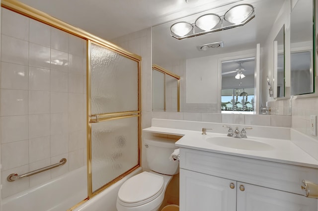 full bathroom with tasteful backsplash, vanity, combined bath / shower with glass door, ceiling fan, and toilet