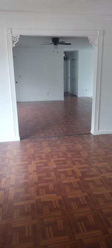 spare room with dark parquet flooring