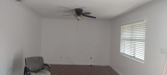 living area with ceiling fan and ornamental molding