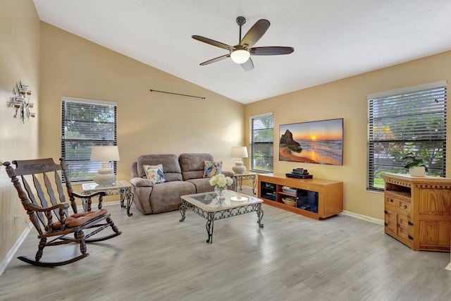 living room with light wood-type flooring, a healthy amount of sunlight, ceiling fan, and lofted ceiling