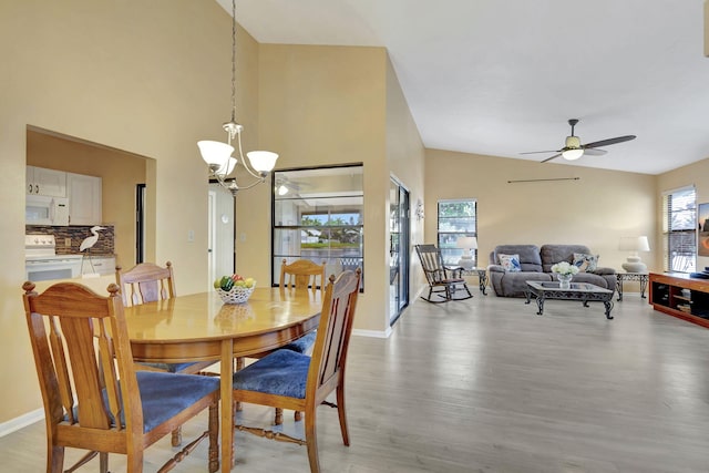 dining area featuring ceiling fan with notable chandelier and hardwood / wood-style floors