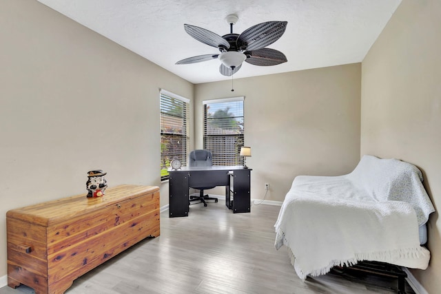 bedroom with hardwood / wood-style flooring and ceiling fan