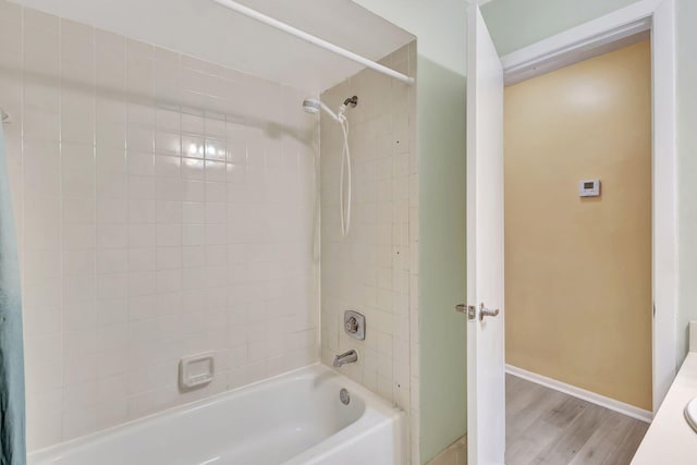 bathroom with vanity, hardwood / wood-style flooring, and shower / bathtub combination with curtain