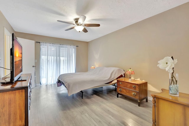 bedroom featuring light hardwood / wood-style floors and ceiling fan