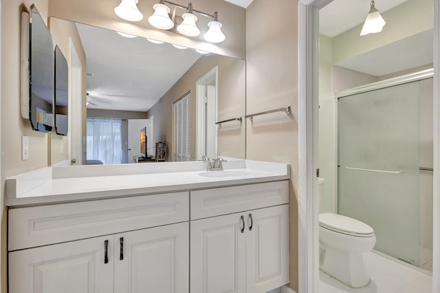 bathroom featuring an enclosed shower, tile patterned flooring, vanity, ceiling fan, and toilet