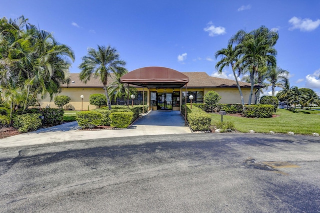 exterior space featuring a front yard and a carport