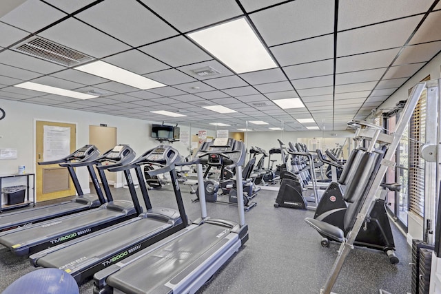 exercise room with a paneled ceiling