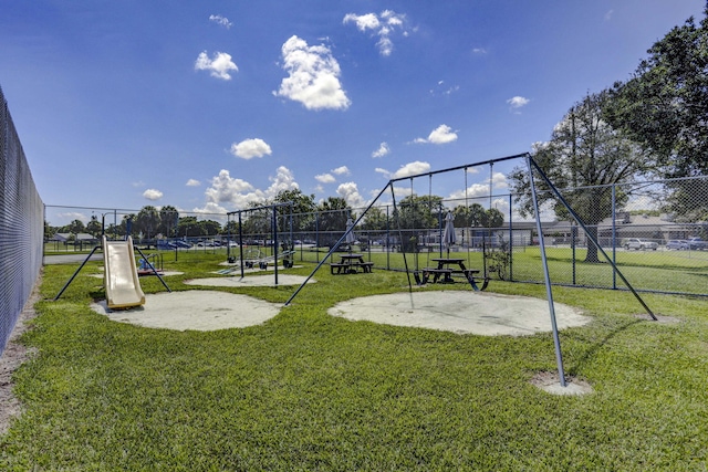 view of home's community with a playground and a yard