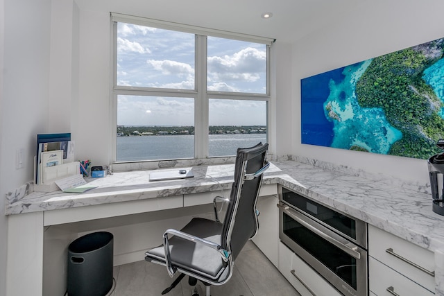 office space featuring a water view and built in study area