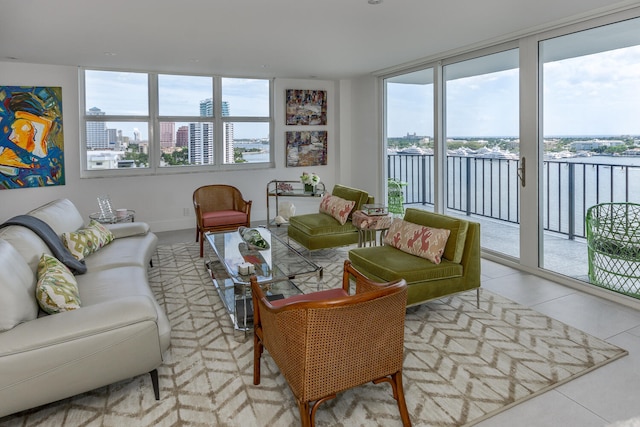 living room with light tile patterned floors, plenty of natural light, a water view, and a city view