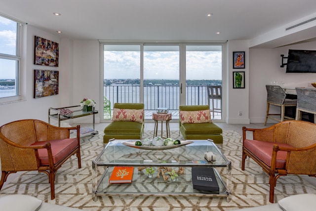 living room featuring expansive windows, recessed lighting, visible vents, and baseboards