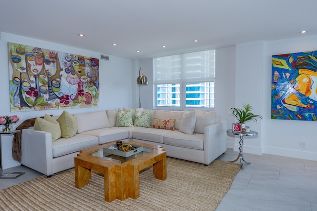 living room featuring baseboards, visible vents, and recessed lighting