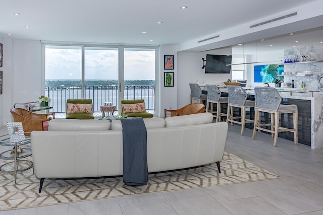 tiled living room featuring expansive windows