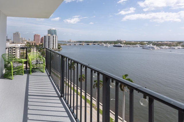 balcony with a view of city and a water view