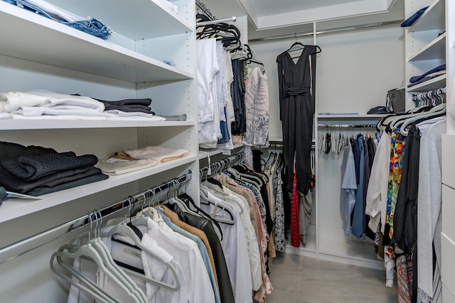 walk in closet with tile patterned flooring