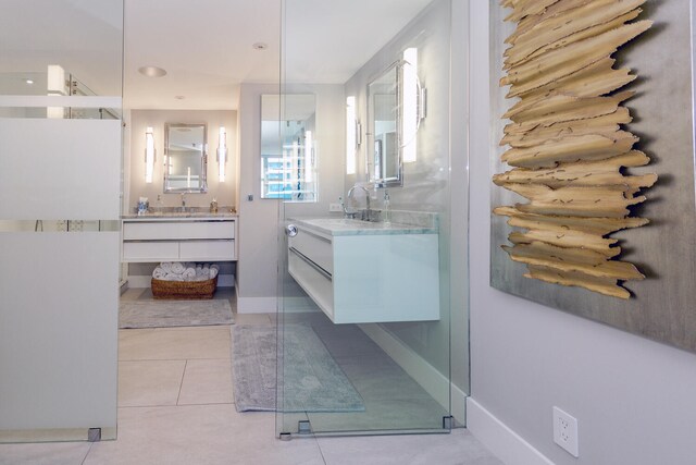 bathroom featuring tile patterned floors, an enclosed shower, and vanity