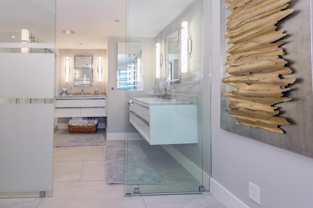 bathroom featuring tile patterned floors, a stall shower, and vanity