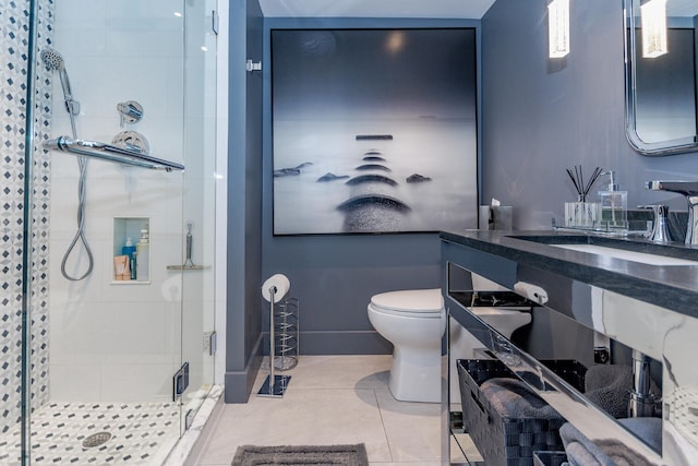 bathroom featuring a sink, tile patterned flooring, toilet, and a shower stall