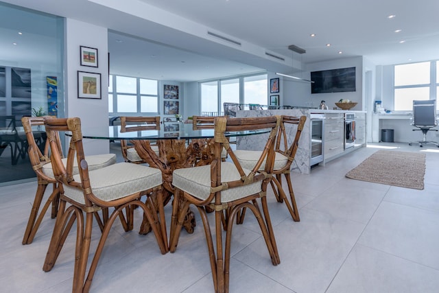 dining room with recessed lighting, beverage cooler, and light tile patterned floors