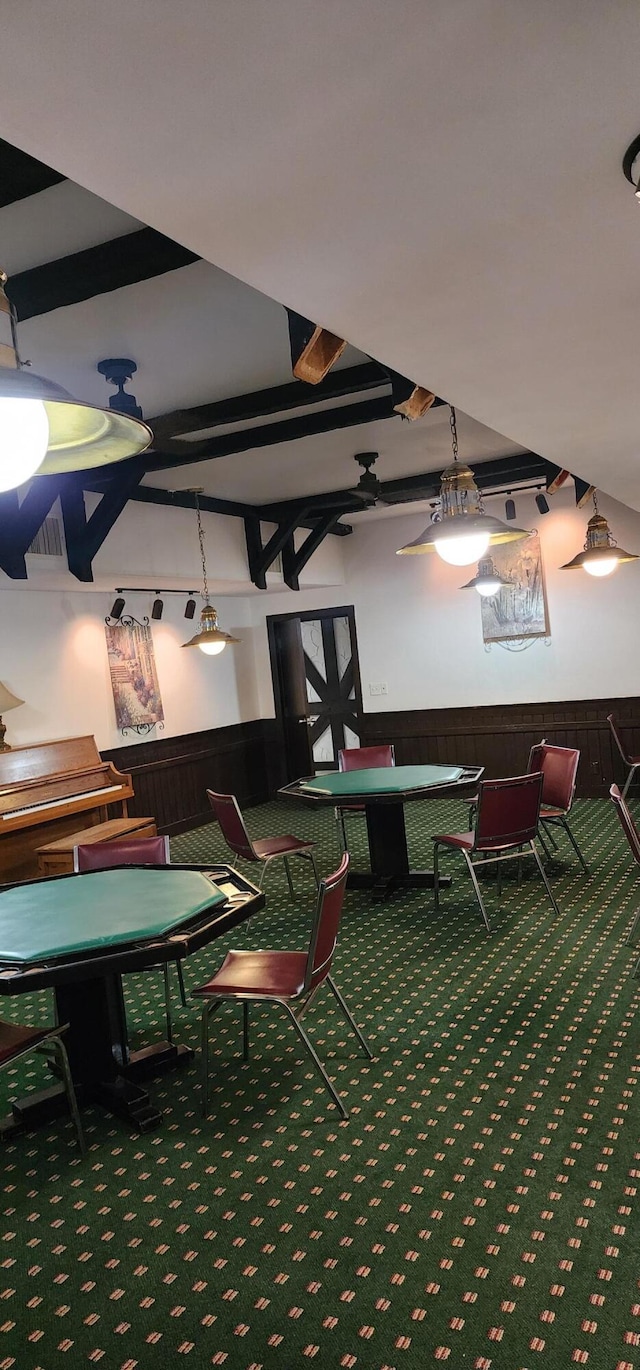 interior space featuring carpet floors and beamed ceiling