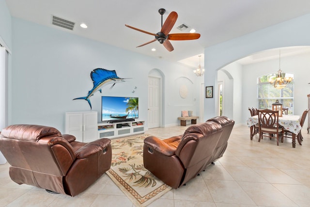 living room featuring ceiling fan with notable chandelier and light tile patterned flooring