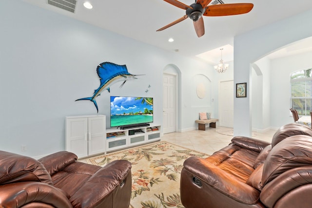 tiled living room with ceiling fan with notable chandelier