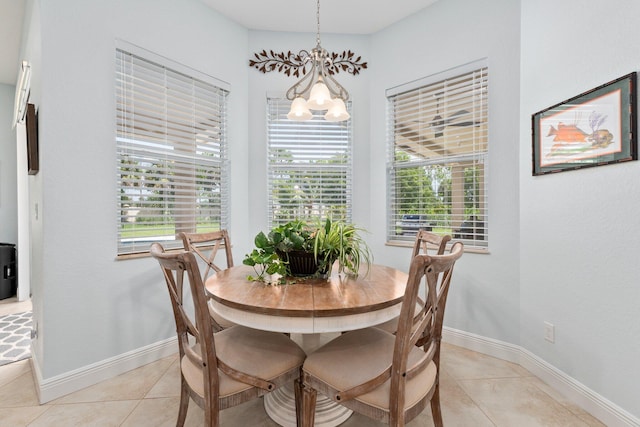 tiled dining area featuring a wealth of natural light and an inviting chandelier