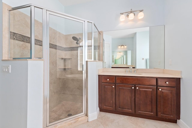 bathroom with a shower with shower door, tile patterned flooring, and vanity