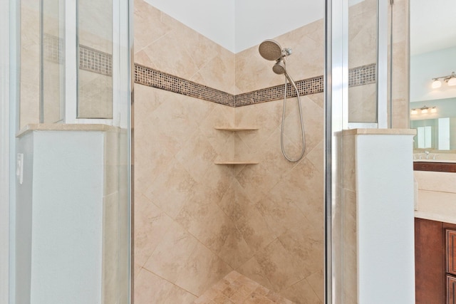 bathroom featuring an enclosed shower and vanity