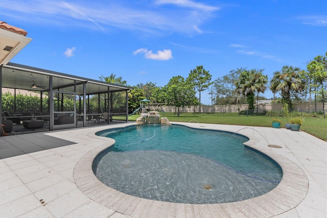 view of pool with pool water feature, a patio area, and a yard