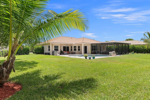 rear view of property with a lawn and a patio area