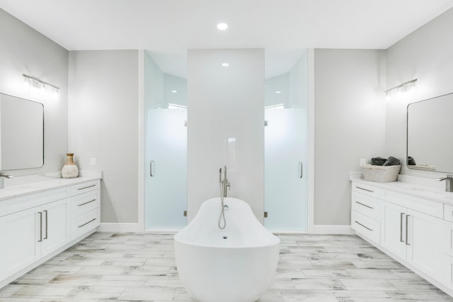 bathroom featuring hardwood / wood-style flooring, shower with separate bathtub, and vanity