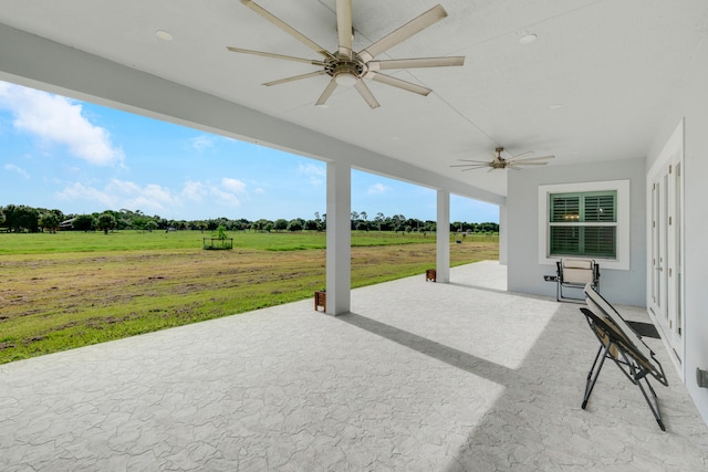 view of patio / terrace featuring a rural view and ceiling fan