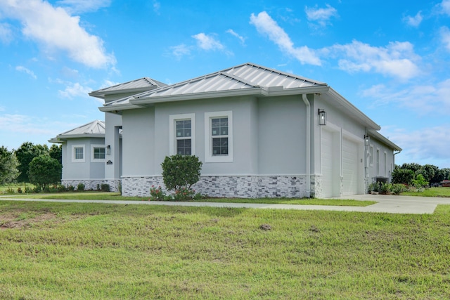 view of front of home featuring a garage and a front lawn