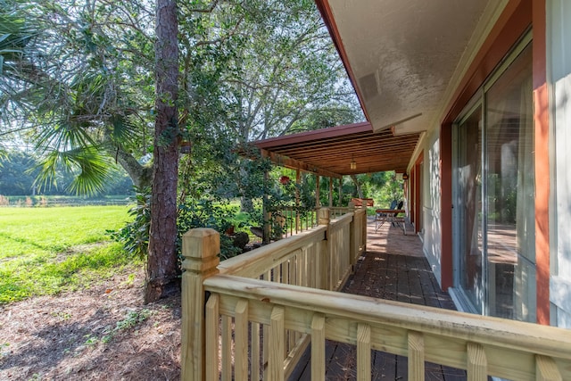 wooden terrace with a lawn