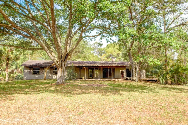 back of house with a yard