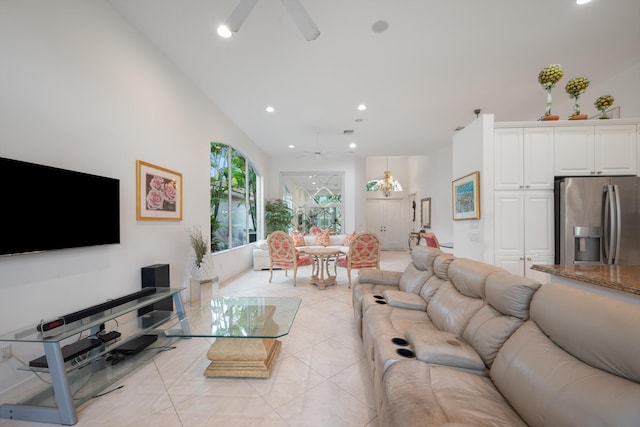 living room featuring light tile patterned floors, ceiling fan with notable chandelier, and vaulted ceiling