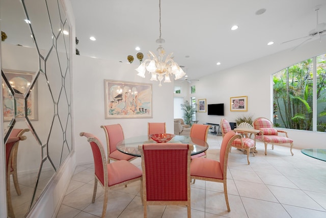 dining area with ceiling fan with notable chandelier and light tile patterned floors