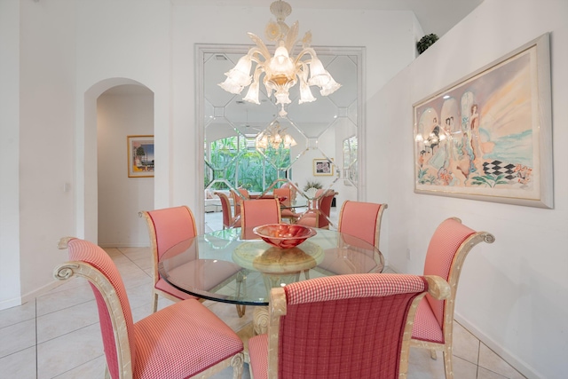 tiled dining room with a chandelier