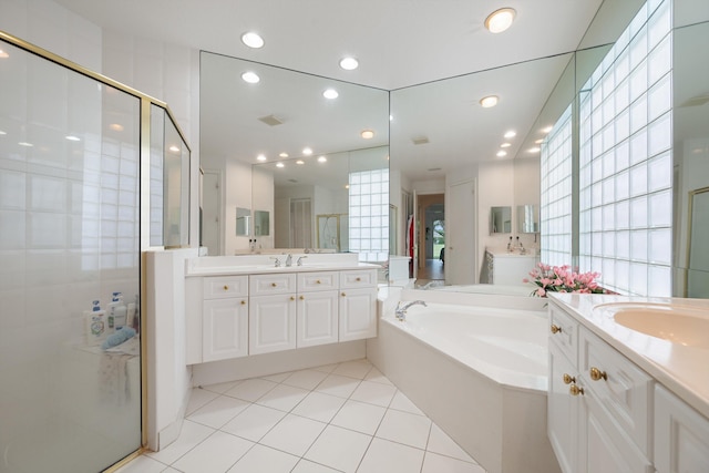 bathroom featuring vanity, independent shower and bath, and tile patterned floors