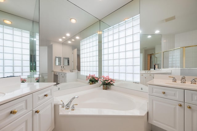 full bathroom with vanity, independent shower and bath, and toilet