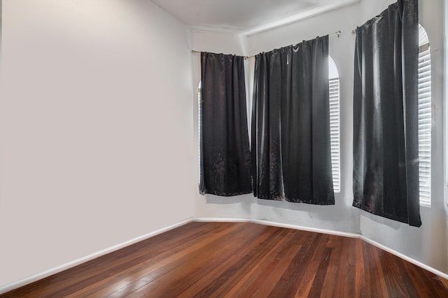 unfurnished room with dark hardwood / wood-style floors