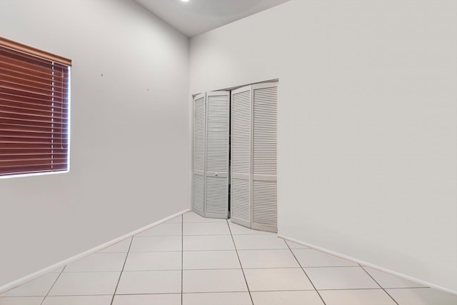 unfurnished bedroom featuring a closet and light tile patterned floors