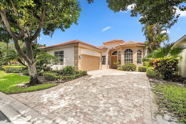 mediterranean / spanish house with a garage