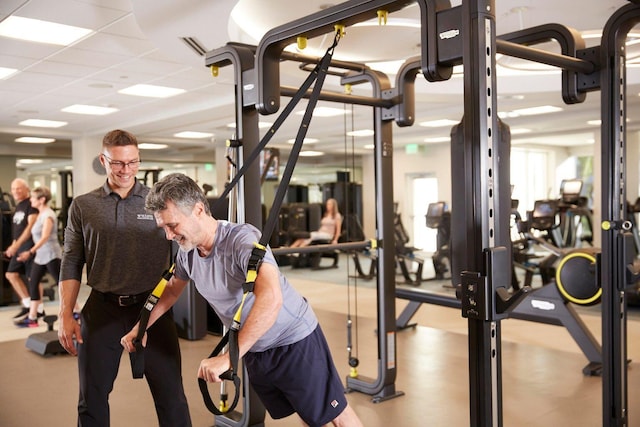 workout area featuring a paneled ceiling