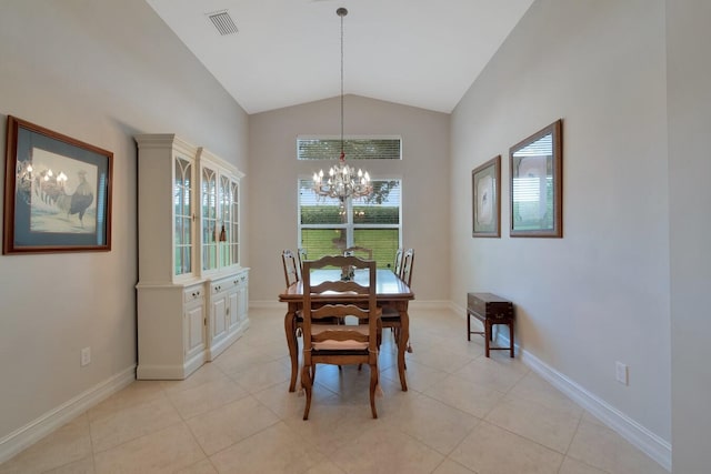 dining room with vaulted ceiling, a chandelier, and light tile patterned flooring