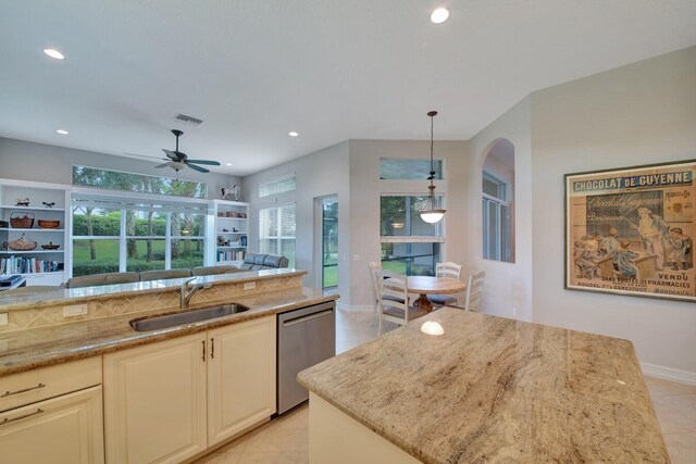 kitchen with stainless steel dishwasher, ceiling fan, sink, and a healthy amount of sunlight