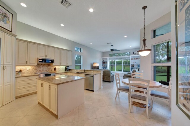 kitchen featuring ceiling fan, stainless steel appliances, pendant lighting, and a healthy amount of sunlight